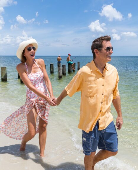 Couple walking on beach holding hands