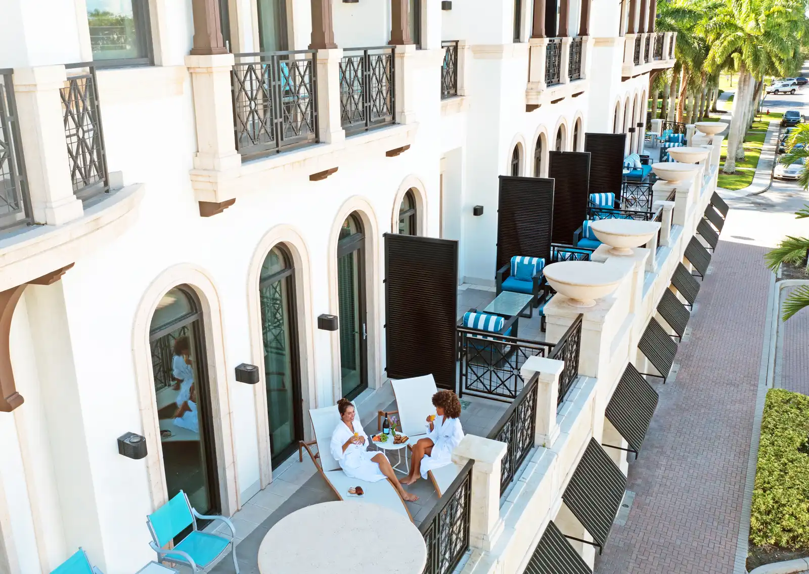 Women on balcony in robs sitting